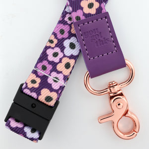 Floral-patterned lanyard with purple accent and rose gold clasp on a white background