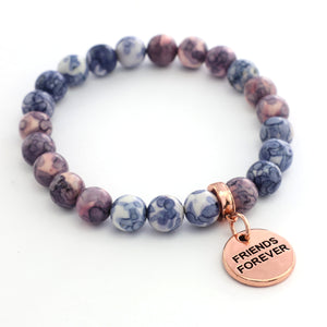 Bracelet with marbled beads and a rose gold 'Friends Forever' charm on a white background
