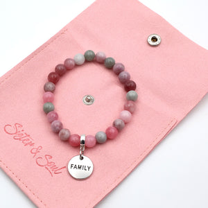 Beaded bracelet with 'FAMILY' charm on a pink card, featuring the brand 'Sister & Co.'