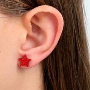 Red glitter star in girls ear
