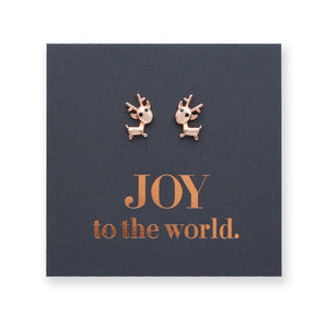 Rose gold reindeer Christmas stud earrings on a black card that says 'Joy To The World'.