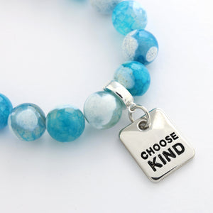 Blue beaded bracelet with a silver 'CHOOSE KIND' charm on a white background