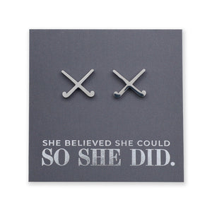 Silver hockey stud earrings on a card with 'She believed she could so she did' text