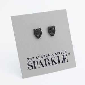 Black cat-shaped earrings on a card with 'She leaves a little sparkle' text.