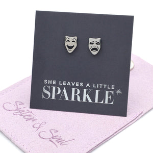 Pair of earrings on a card with 'She leaves a little sparkle' text on a pink surface.