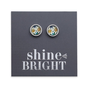 Pair of floral stud earrings on a gray card with 'shine bright' text