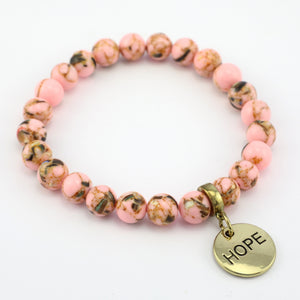 Beaded bracelet with a 'HOPE' charm on a white background