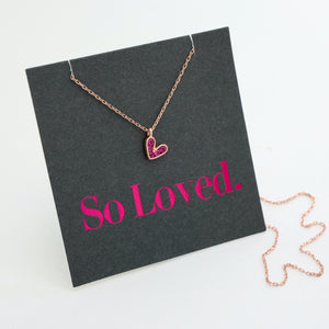 Pink heart pendant necklace sterling silver with 18K rose gold plating on gift card that has text that says so loved.