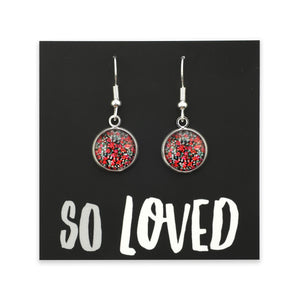Pair of earrings with red and silver design on a 'SO LOVED' card