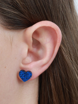 Beautiful Strong Unique heart acrylic glitter stud earrings in dark blue glitter worn on an ear to show size and fit