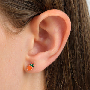 Girl wearing carrot earring.