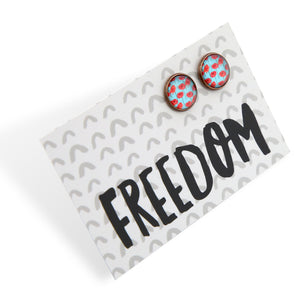 Earrings with floral design on a card with 'FREEDOM' text
