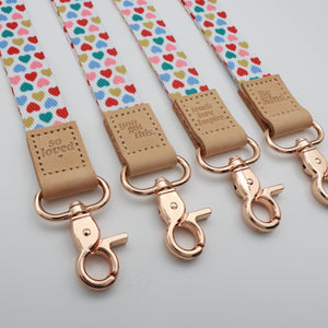 Sweet Hearts lanyards showing Be Kind, Teach Love Inspire, You Got This and So Loved embossed trims and lobster clasps.