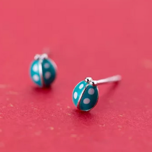 Tiny sterling silver earring studs in lady beetle shape with teal coloured enamel. Novelty shaped earrings.