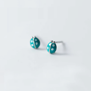 Tiny sterling silver earring studs in lady beetle shape with teal coloured enamel. Novelty shaped earrings.