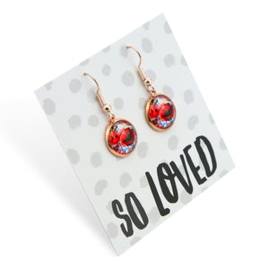 Rose gold earrings with floral design on a 'So Loved' card