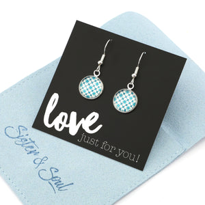 Teal print silver dangle earrings on love and inspiring word card on white background.