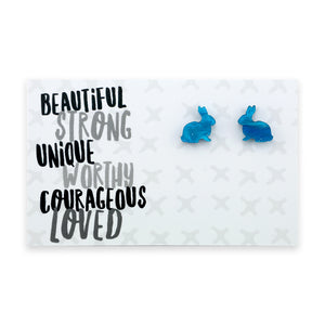 A pair of teal blue acrylic bunny stud earrings on a white display card with the words 'BEAUTIFUL STRONG UNIQUE WORTHY COURAGEOUS LOVED' written at the top.