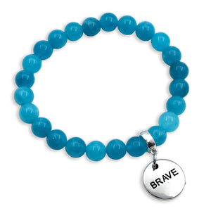 Blue beaded bracelet with a 'BRAVE' charm on a white background