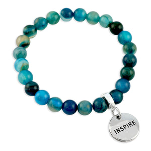 Blue beaded bracelet with a 'Inspire' charm on a white background