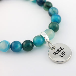 Beaded bracelet with a silver 'RISE UP' charm on a white background