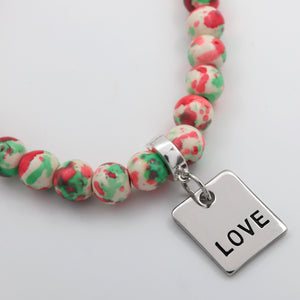 Beaded bracelet with a 'LOVE' charm on a light background