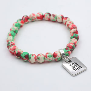 Beaded bracelet with a 'You Got This' charm on a light gray background