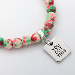 Bracelet with colorful beads and a silver charm reading 'You Got This' on a white background