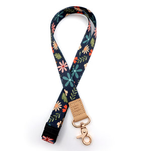 Floral patterned lanyard with a gold buckle on a white background