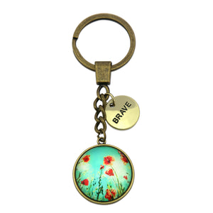 Keychain with floral design and 'BRAVE' tag on a white background