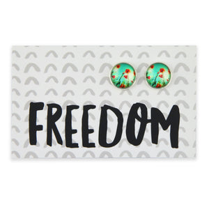 Pair of earrings with floral design on a card with 'FREEDOM' text