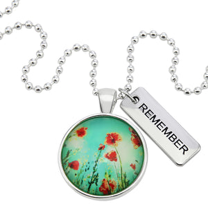 Necklace with floral pendant and 'REMEMBER' tag on a white background