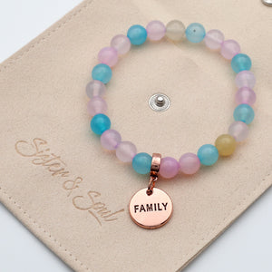 Multicolored beaded bracelet with a 'FAMILY' charm on a beige card.
