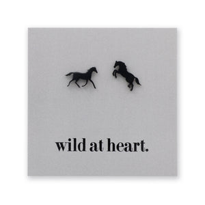 Black horse earrings on a black card with 'wild at heart.' text
