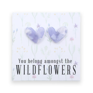 Heart-shaped earrings on a card with 'You belong amongst the wildflowers.' text