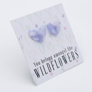 Heart-shaped earrings on a card with 'You belong amongst the wildflowers.' text