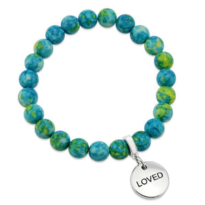 Stone bracelets with blue and green stone beads and silver charms with the words 'strength', 'loved', and 'inspire' on them.