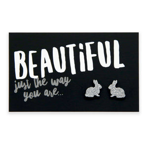 A pair of silver glitter acrylic bunny stud earrings on a black background with the text 'BEAUTIFUL just the way you are...'