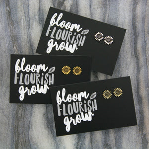 a set of different coloured sunflower earrings