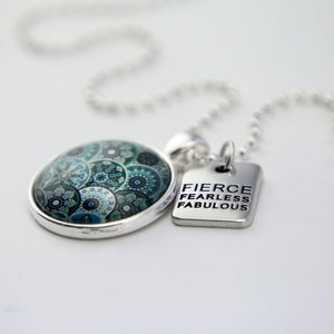Teal print mandala pendant necklace in bright silver with fierce fearless fabulous charm.