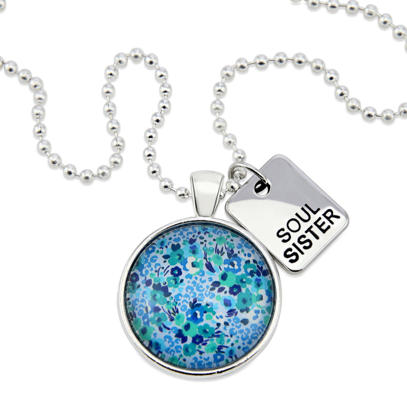 Teal floral print pendant necklace in bright silver with soul sister charm. 