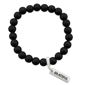 Black onyx stone bead bracelet with silver meaningful charm.