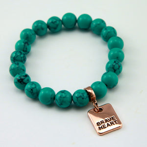 Teal stone bead bracelet with rose gold charm.