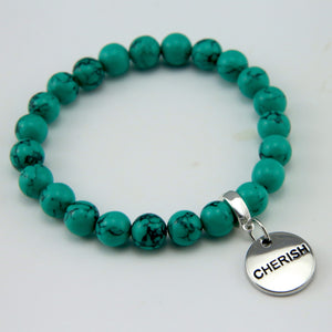 Teal coloured stone bead bracelet with silver meaningful word charm.