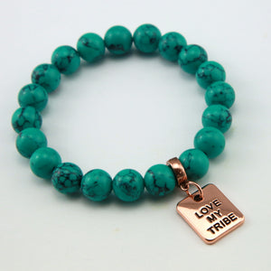 Teal coloured stone bracelet with word charm and rose gold clip.