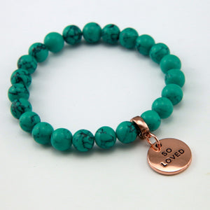 Teal coloured stone bead bracelet with rose gold charm