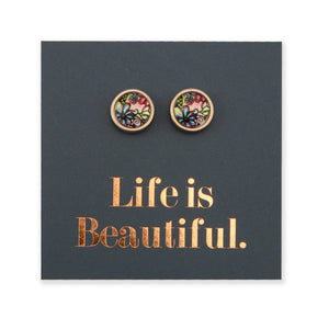 A pair of rose gold stainless steel circle stud earrings with a floral pattern, displayed on a card with the text 'Life is Beautiful'.