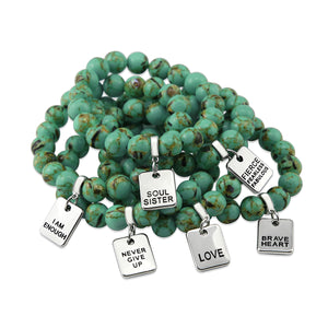 Teal coloured stone bead bracelet with meaningful word charm.
