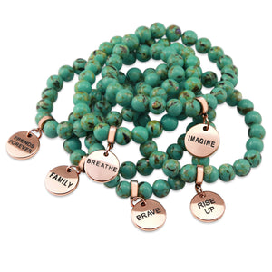 Light teal stone bead bracelet with rose gold meaningful word charm.