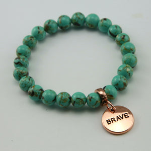 Light teal stone bead bracelet with rose gold meaningful word charm.